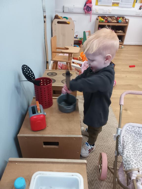 Cooking up a treat in our role play kitchen area to encourage imagination and communication